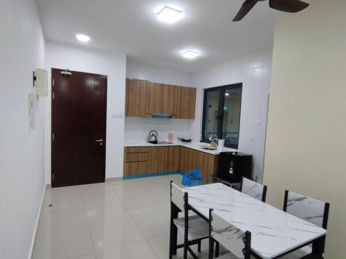 a kitchen with a table and chairs in a room at 1 bed room service apartment for 3 guests in Petaling Jaya