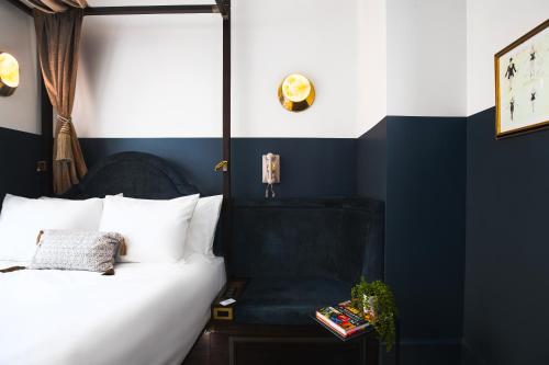 a bedroom with a bed and a chair at CIVILIAN Hotel in New York