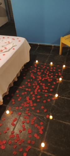 a room with hearts on the floor next to a bed at POUSADA MAORI Boiçucanga in Boicucanga