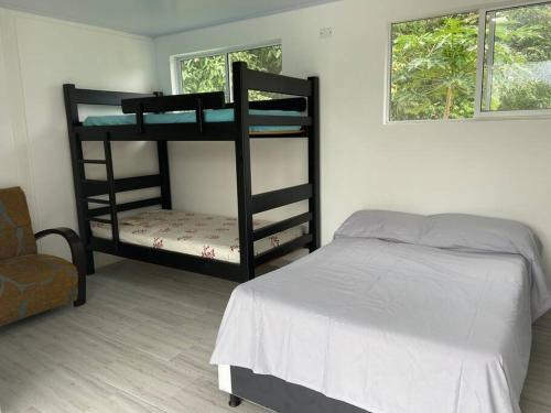 a bedroom with two bunk beds and a bed at Villa Sandra - Casa de campo, Acacias- Guamal in Guamal