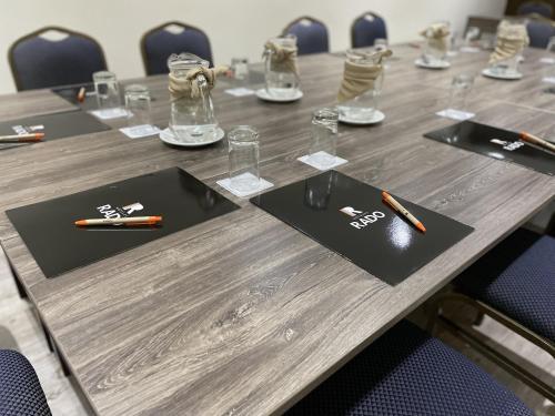 a wooden table with pens on top of it at Rado Hotel - Quintanas in Trujillo