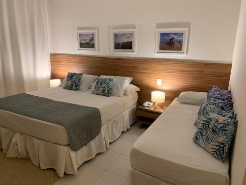 a hotel room with two beds and two lamps at Pérola do Tree Bies Resort in Entre Rios