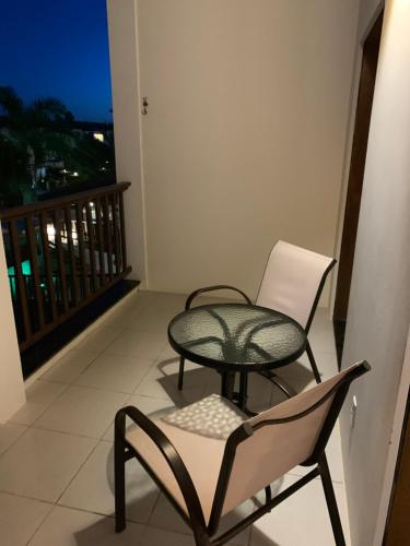 a table and a chair on a balcony at Pérola do Tree Bies Resort in Entre Rios