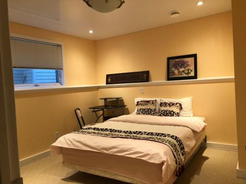 a bedroom with a bed and a window at citadle hill house! in Calgary