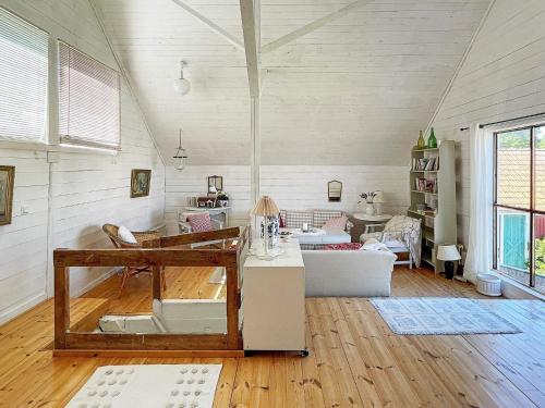 a living room with a couch and a table at Holiday home ELLÖS IX in Ellös