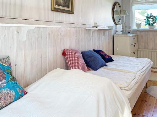 two beds sitting next to each other in a room at 5 person holiday home in ELLÖS-By Traum in Ellös
