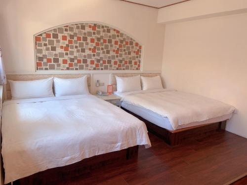 Ένα ή περισσότερα κρεβάτια σε δωμάτιο στο Traveler Hotel Taitung