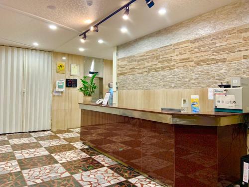 a lobby with a cash counter and a brick wall at Traveler Hotel Taitung in Taitung City