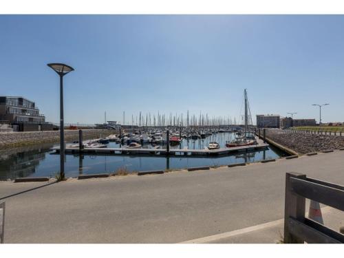 a marina with boats docked in a harbor at Apartment in Sint-Annaland with Water Views in Sint Annaland