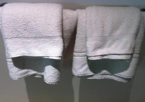 two towels hanging on a towel rack in a bathroom at Keerawadee Two Bedroom House 