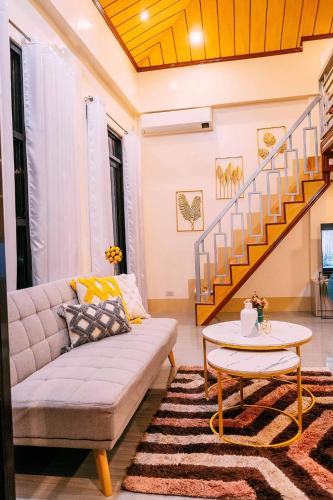 a living room with a couch and a table at Palompon kalimba de luna Villa Inn in Leyte