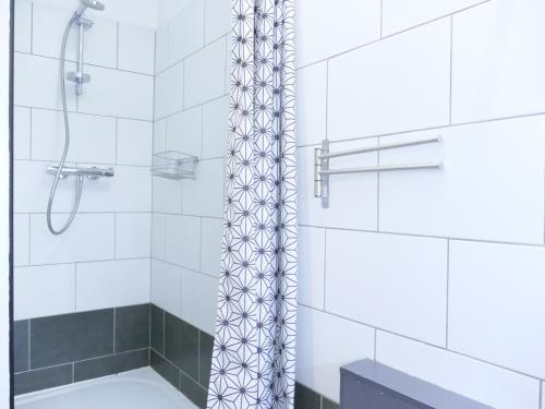 une salle de bain avec une douche avec un rideau de douche dans l'établissement Appartement cosy pour 6 personnes avec terrasse aux Deux Alpes - FR-1-546-48, à Les Deux Alpes
