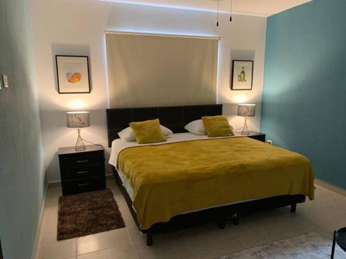 a bedroom with a large bed with two lamps at Apartamento exclusivo piscina, jaccuzi, céntrico. in Cancún