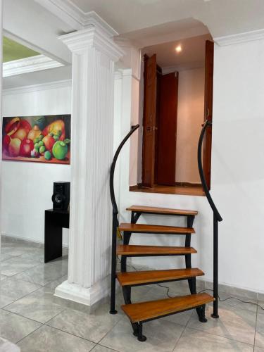 a staircase in a room with a painting on the wall at CASA CON JACUZZI CENTRO PEREIRA in Pereira
