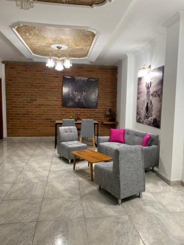 a living room with two couches and a table at CASA CON JACUZZI CENTRO PEREIRA in Pereira