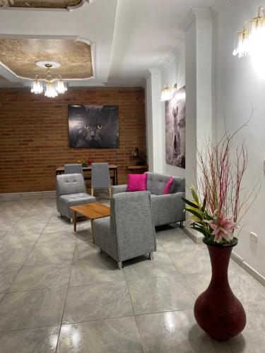 a living room with couches and a table and chairs at CASA CON JACUZZI CENTRO PEREIRA in Pereira