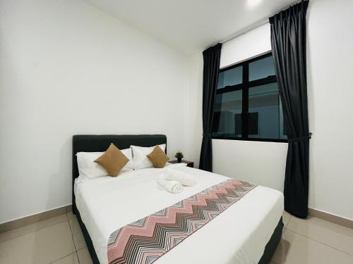 a bedroom with a large white bed with a window at Desaru Johor by Glex in Desaru