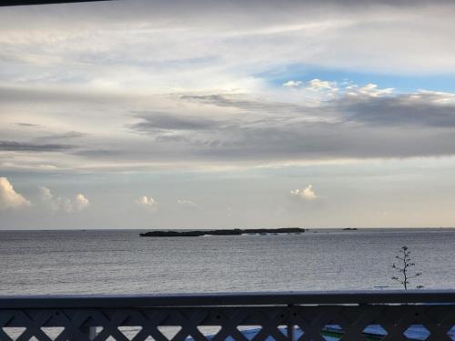 an island in the ocean under a cloudy sky at My Little Shack by the Sea in Lajas