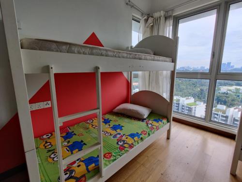 a bunk bed with a red and white bunk bed in a room at StarsBed KLCC Skyview Roof Pool Hostel in Kuala Lumpur