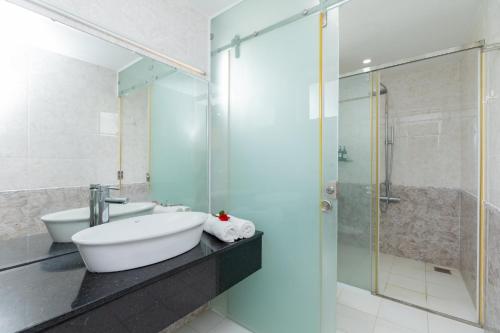 a bathroom with a sink and a shower at Palm Villa 39 - Luxury Free Bida & Karaoke in Vung Tau