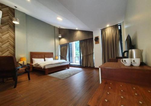a bedroom with a bed and a large window at Marco Polo Resort Kaghan in Kāgān