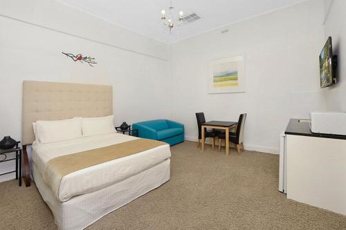 a bedroom with a bed and a desk and a table at Lavender House York in York