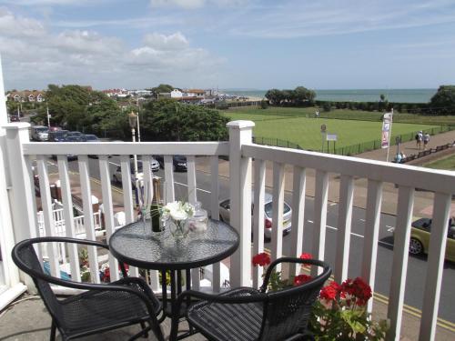 a table and chairs on a balcony with a view of a street at Ebor Lodge in Eastbourne