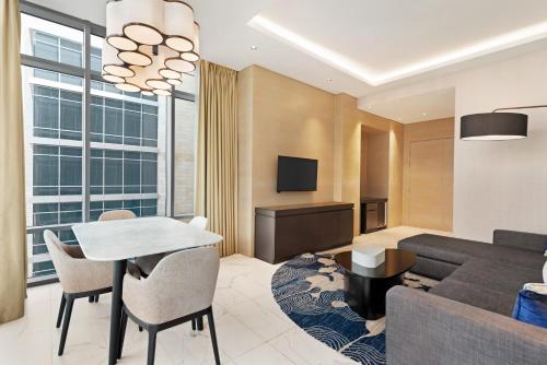 a living room with a couch and a table at Novotel Dubai Gold District in Dubai