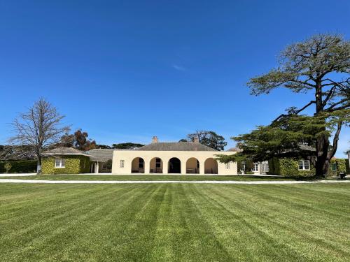 a large grass field in front of a house at Mount William Station in Willaura