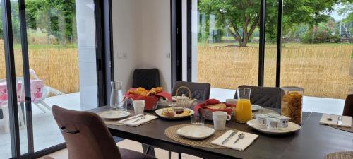 a dining room table with food and drinks on it at Ferme Peyroutet in Asson