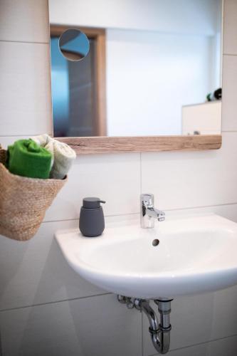 a bathroom with a sink and a mirror at Ferienwohnung Hoamat in Reutte