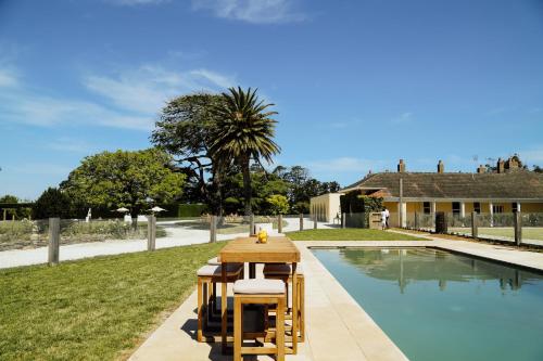 a table and chairs next to a swimming pool at Mount William Station in Willaura