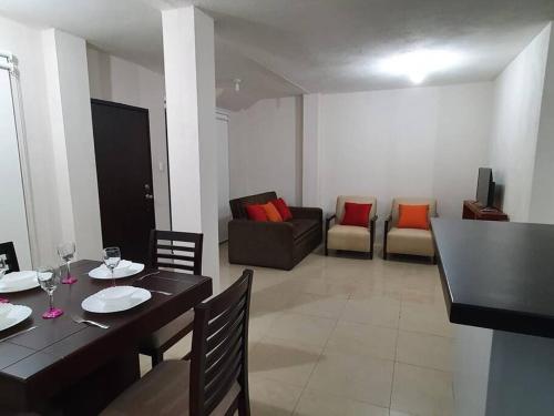 a living room with a table and chairs and a couch at Andy's House in San Cristobal