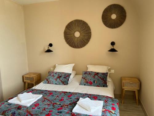 a bedroom with two beds and two mirrors on the wall at La Maison Des Galets sur le front de mer in Saint-Valery-en-Caux