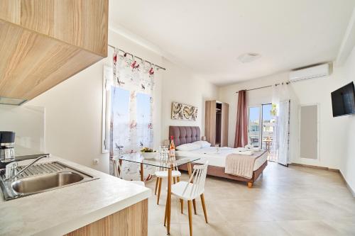 a kitchen and living room with a table and a bed at Adele Apartment in Kissamos