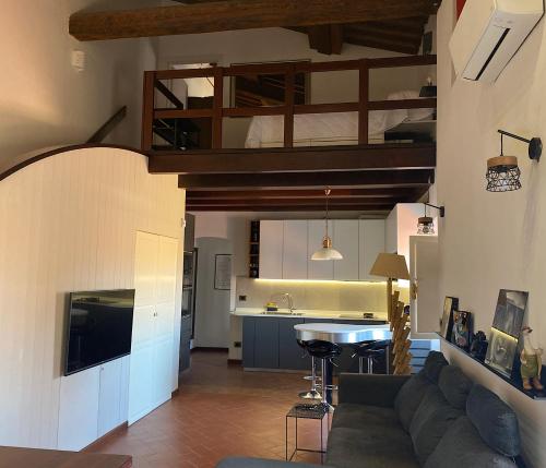 a living room with a couch and a kitchen at TUSCANY LOFT IN THE CITY in Livorno