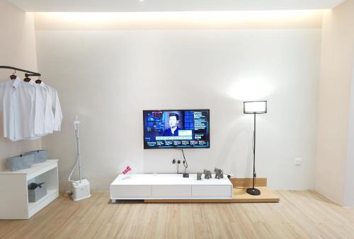 a bathroom with a white tub and a tv on the wall at The Peak - Bangsar South Mid Valley in Kuala Lumpur