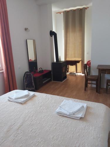 a bedroom with a bed and a table and a mirror at Apartman Brina in Kanfanar