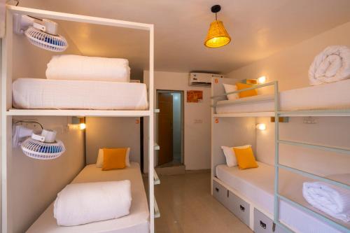 two bunk beds in a room with yellow and white towels at Zostel Rishikesh, Laxman Jhula in Rishīkesh