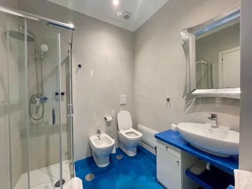 a bathroom with a sink and a toilet and a shower at Tribus Boutique Hotel in Torre Annunziata