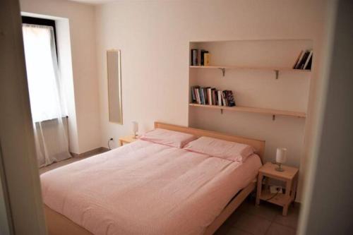 een kleine slaapkamer met een bed en een raam bij Le Androne di Trento in Trento