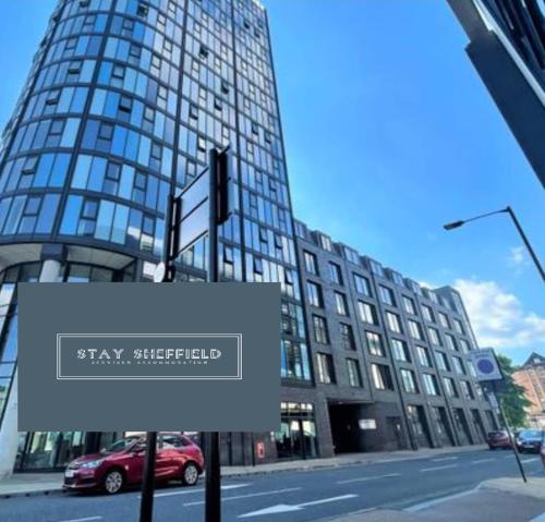 a sign in front of a tall building at City Centre 2 Bedroomed Apartment - Great views - wifi in Sheffield
