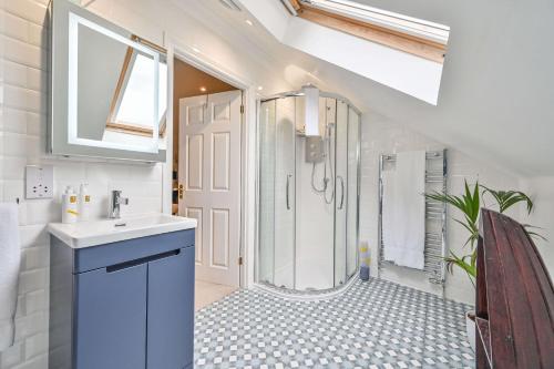 a bathroom with a sink and a shower at Lisburne Place - Luxury Three Bedroom Town House in Torquay