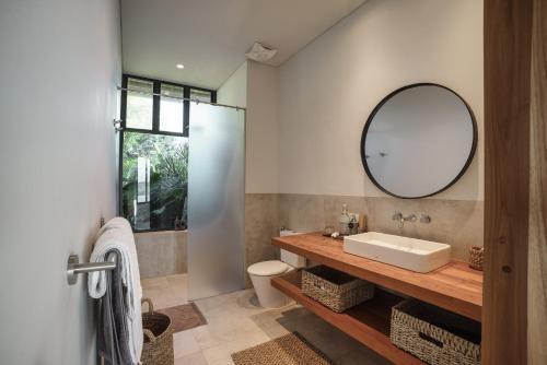 a bathroom with a sink and a mirror at Villa Utamaro in Bumbang