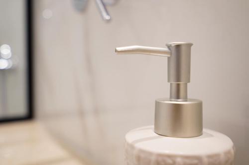 a metal faucet on top of a bathroom sink at Estilo luxury apartment in Kavala