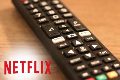 a black remote control sitting on top of a wooden table at Estilo luxury apartment in Kavala