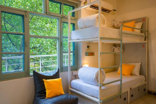 a room with a shelf with towels and a couch at Zostel Rishikesh, Laxman Jhula in Rishīkesh