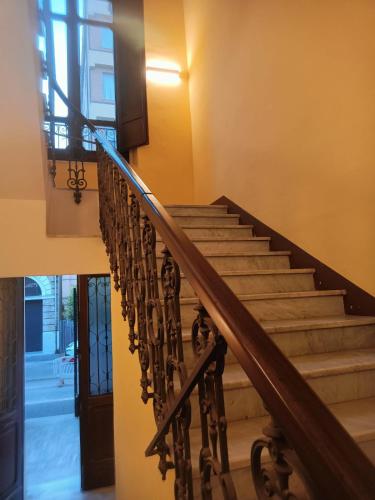 a staircase in a building with a wooden rail at B&B Lanciano in Lanciano