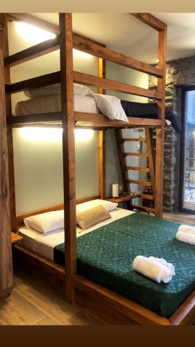 a bunk bed in a room with two bunk beds at ΧΑΡΟΥΛΑ STUDIO in Pavliani