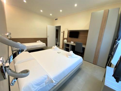 a hospital room with a bed and a television at Levante apartment and room in Bari